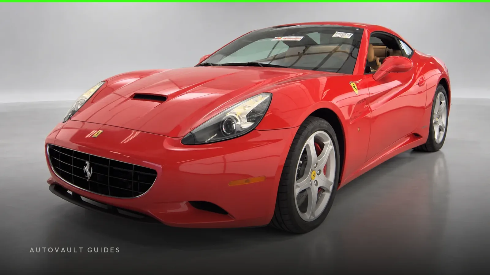 A red 2010 Ferrari California in the AutoVault studio, front three-quarter view.